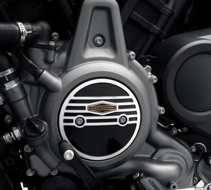 Silver circle alternator plug cover with black detailed and gold Harley-Davidson logo